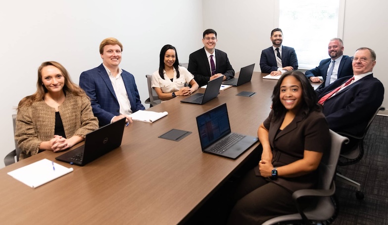 Grabowski & Lipack Team together at a conference table